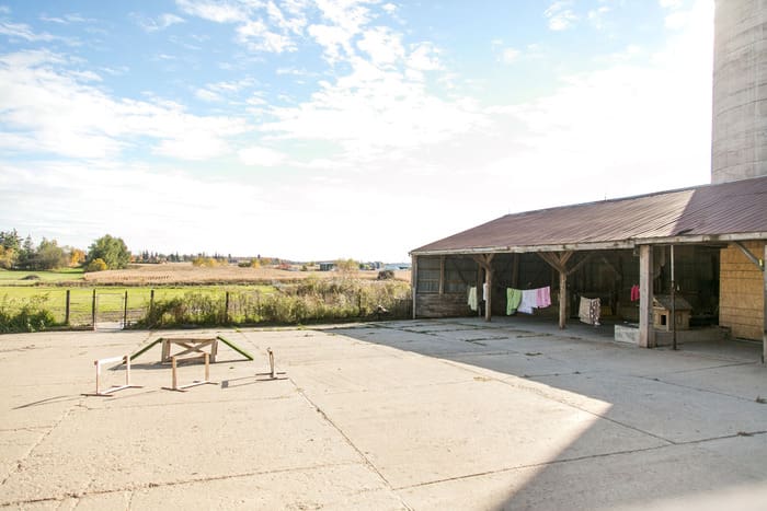 A large open area with a picnic table and covered parking lot.